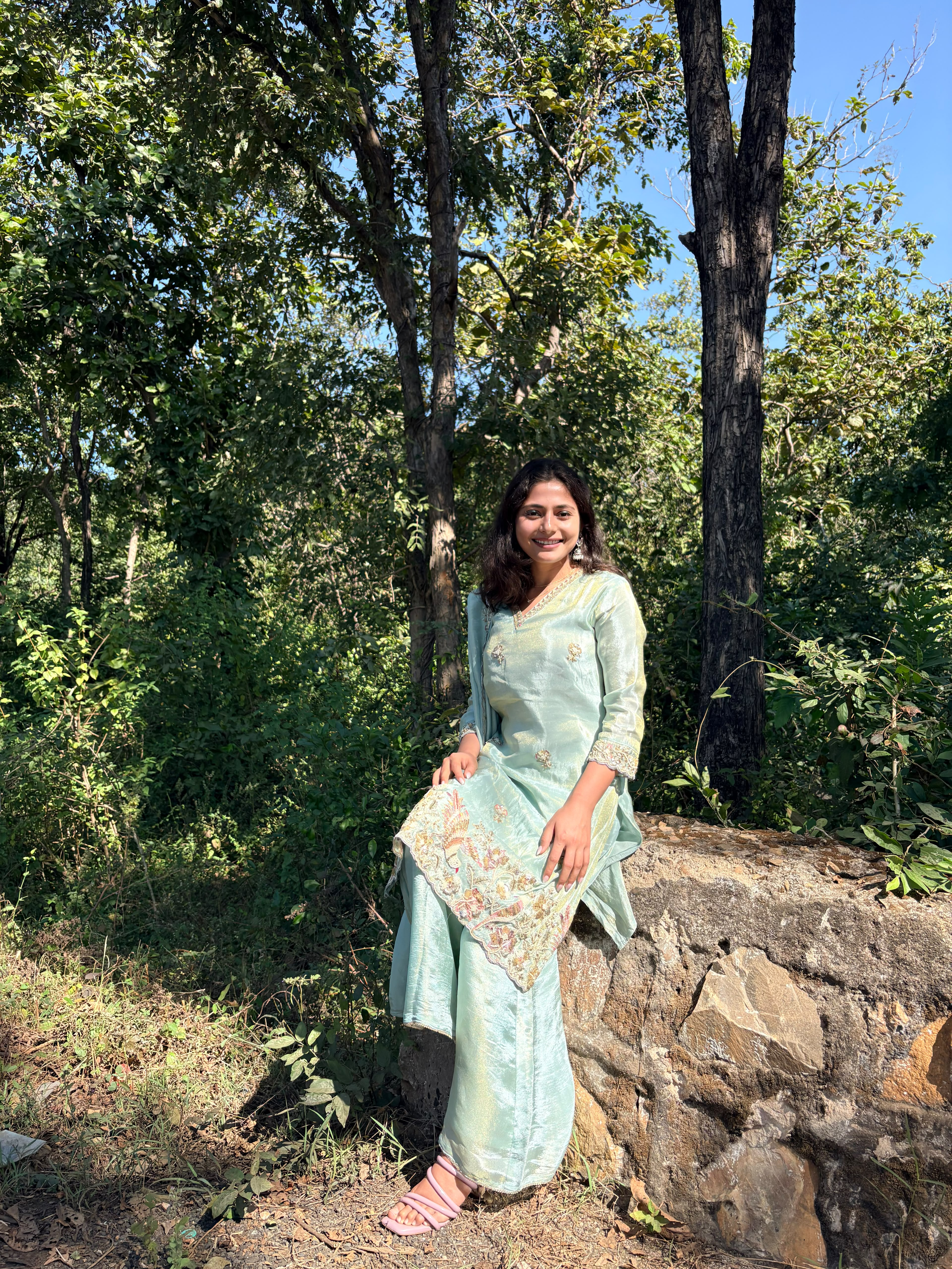 Khushboo in a mint outfit among trees